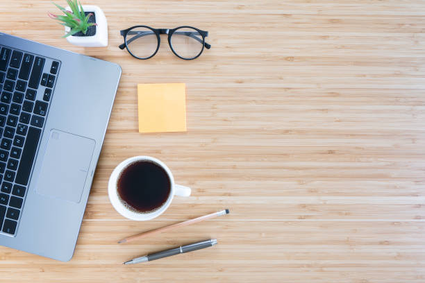istock flat lay composition with notebook, pen, coffee, plant, laptop on wood background. top view 1316630837