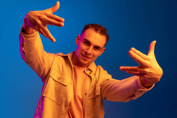 istock Caucasian young man isolated on blue studio background in neon. Concept of human emotions, facial expression. 1316632785