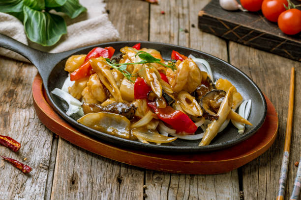 istock Grilled seafood on a wok with vegetables on old wooden table Chinese cuisine 1316636054