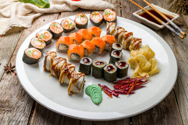 istock set of sushi  rolls on white plate on old wooden table 1316636472