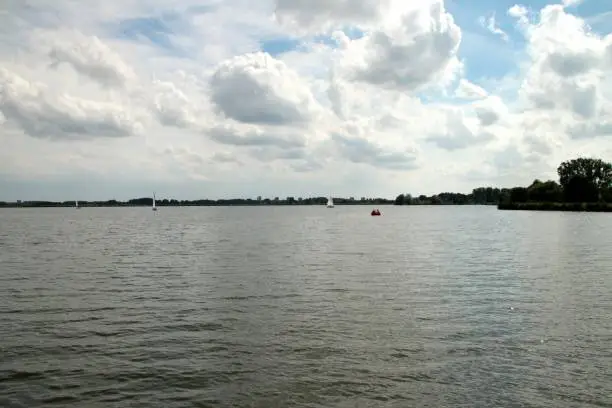 Rottemeren lake with lot of small sailingboats and city of Rotterdam on background skyline
