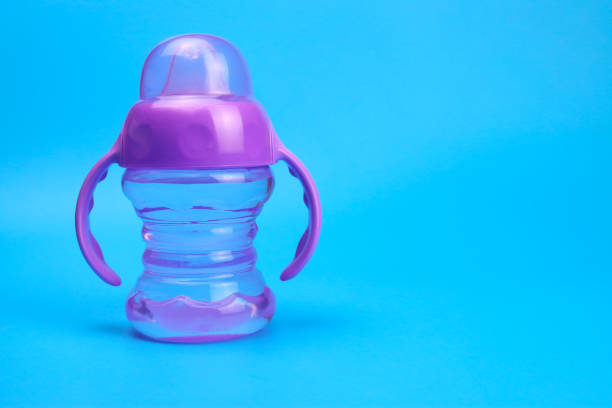istock baby bottle isolated on blue background 1316642694