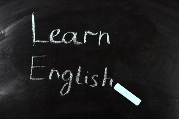 istock Learn English written with chalk on a blackboard, a concept for learning foreign languages 1316643110