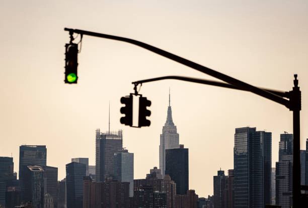 istock Traffic lights with Midtown Manhattan on the background at sunset 1316643254