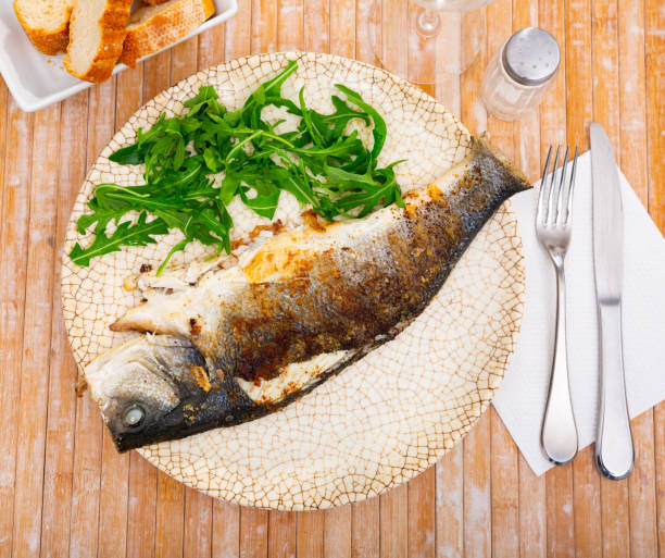 istock Fresh baked fish sea bass with arugula 1316643397