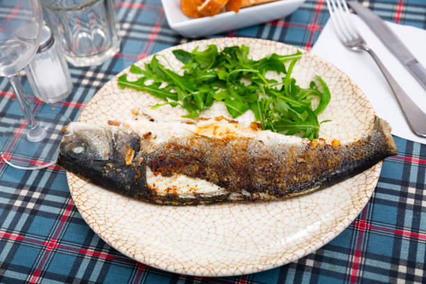istock Fresh baked fish sea bass with arugula 1316643400