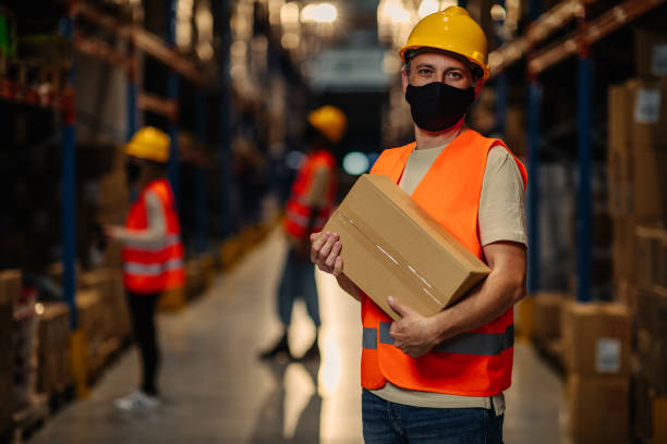 istock Warehouse employe carrying cardboard box 1316644714