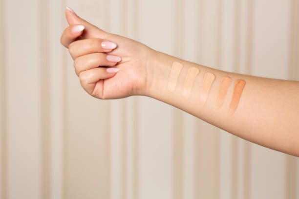 Female hand with swatches of makeup foundation Woman applying shades from light to dark of a liquid makeup foundation on hand. Closeup shot foundation make up stock pictures, royalty-free photos & images