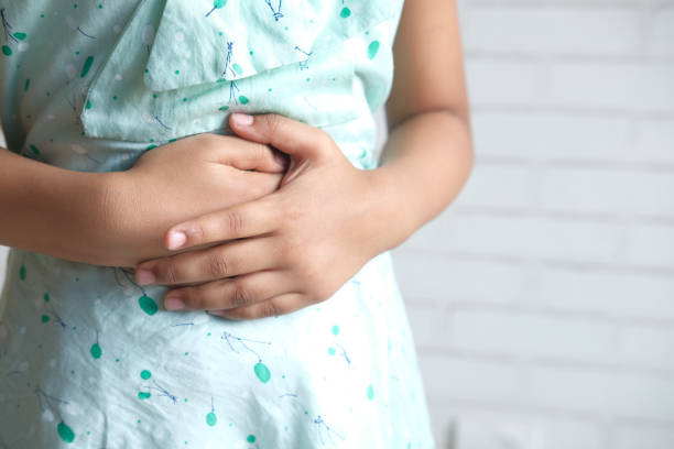 child girl suffering stomach pain close up. child girl suffering stomach pain close up., stomachache stock pictures, royalty-free photos & images