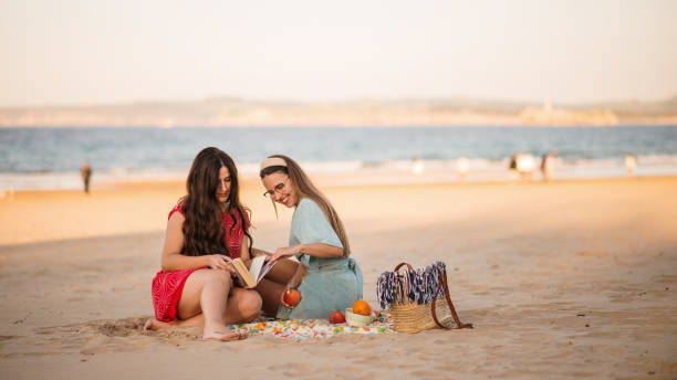 istock Two young women spending time together at a beach 1316648527