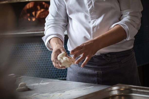 istock Making dough for bread by male hands in restaurant kitchen. Cooking concept. 1316649311