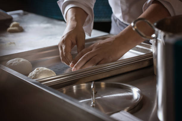 istock Making dough for bread by male hands in restaurant kitchen. Cooking concept. 1316649325