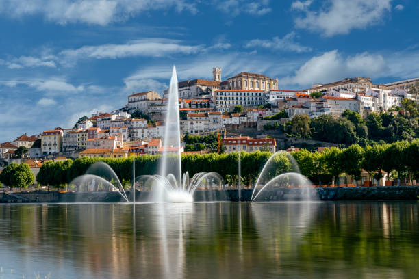 City and university of Coimbra View of the river mondego and coimbra. Fountains in the river. coimbra city stock pictures, royalty-free photos & images