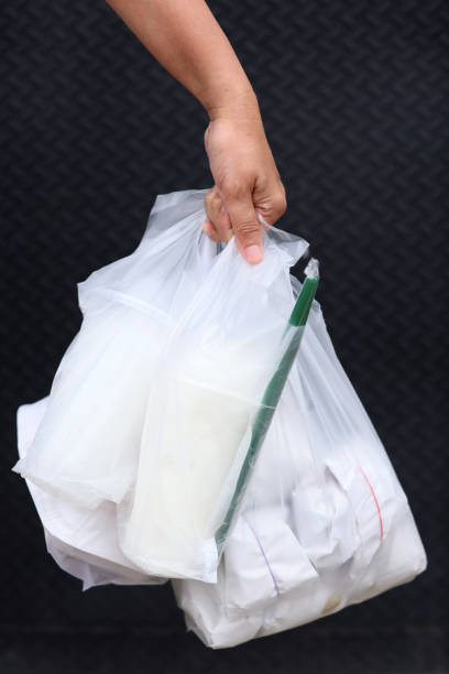 istock Plastic Polution. Every day they used more plastic bag and Coffee mug is Single used Plastic. Hand hold Plastic Waste 1316649422