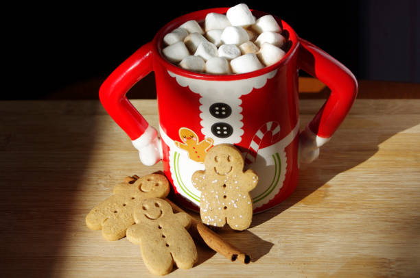 istock three gingerbread cookies in a hot chocolate Mrs. Clause cute mug with marshmallows 1316651369