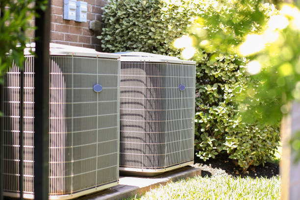 Home air conditioner unit in summer season. Air conditioner unit outdoors in side yard of a brick home in hot summer season.   No people. air conditioner stock pictures, royalty-free photos & images
