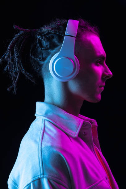 istock Close-up Caucasian young man isolated on dark studio background in neon. Side view 1316651908