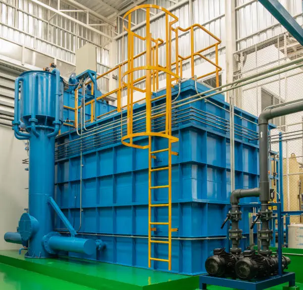 The blue iron sedimentation tank is located in the water filtration system chamber. It has yellow ladders so that the tank can be checked.