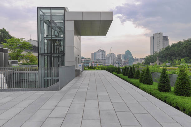 View of glazed building elevator of Ewha Campus Complex on a humid midsummer day in Seoul, South Korea.