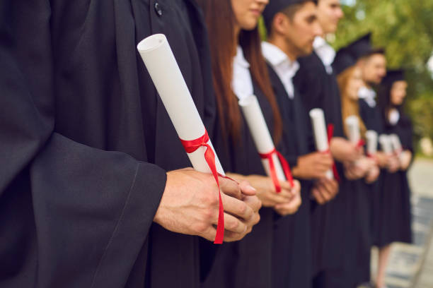 istock University graduates hands holding diplomas after university graduating 1316655806