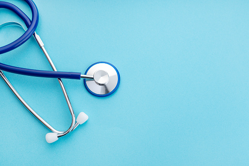 Stethoscope on blue background. Medical concept background. Copy space. Top view