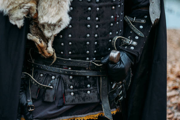 istock Medieval knight with sword in armor in the forest.holds the sword 1316657159