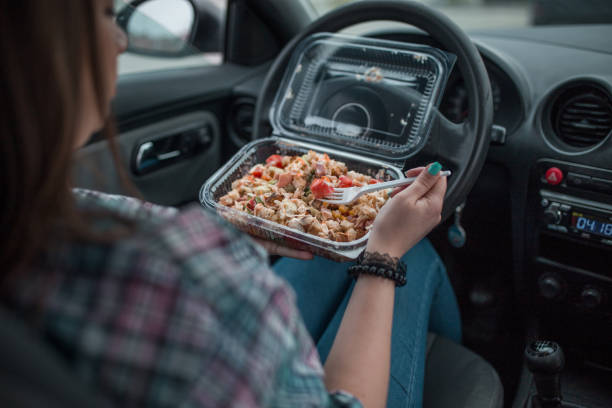istock Female worker eating salad in her car 1316658903