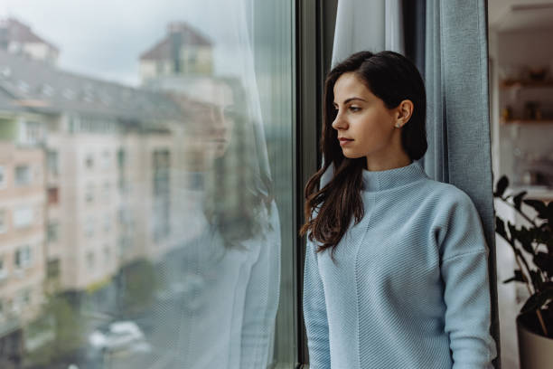 istock Standing next to window, spending day indoor, home. 1316658991