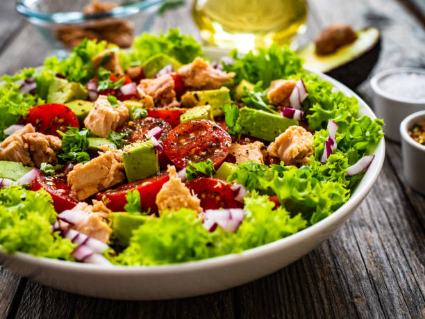 istock Tuna, avocado and vegetable salad  on wooden background 1316659430