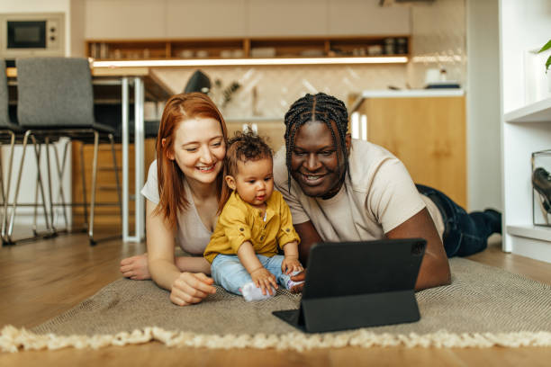 istock Young parents with their baby having fun at home. 1316660080