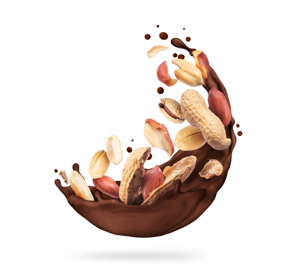 istock Chocolate splashes with crushed peanuts close-up on a white background 1316661703