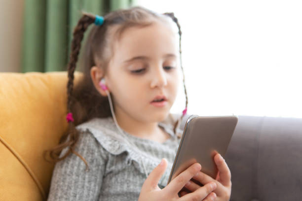 istock little girl using smart phone 1316665934