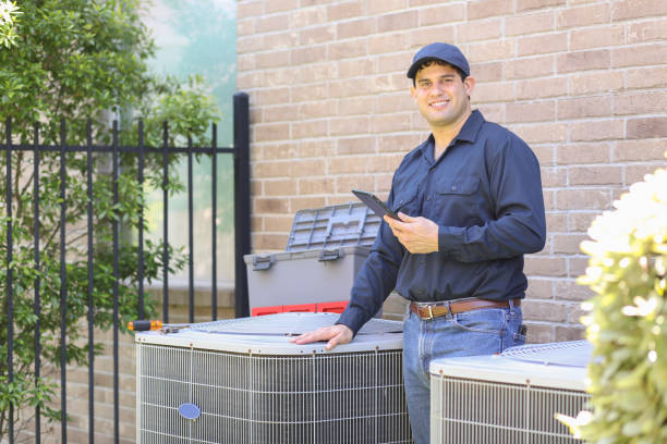 Latin descent, blue collar air conditioner repairman at work. Latin descent, blue collar air conditioner repairman working at residential home.  He prepares to begin work by gathering appropriate tools and referring to digital tablet. air conditioner photos stock pictures, royalty-free photos & images