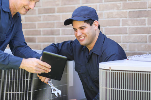 istock Multi-ethnic team of blue collar air conditioner repairmen at work. 1316667082