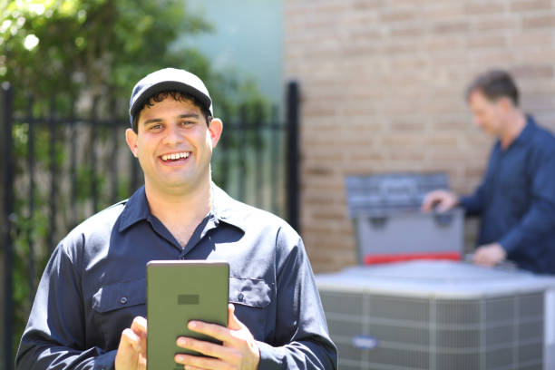 istock Multi-ethnic team of blue collar air conditioner repairmen at work. 1316667121