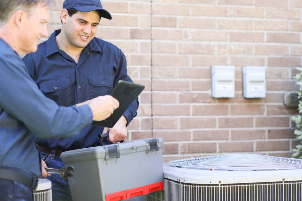 istock Multi-ethnic team of blue collar air conditioner repairmen at work. 1316667145