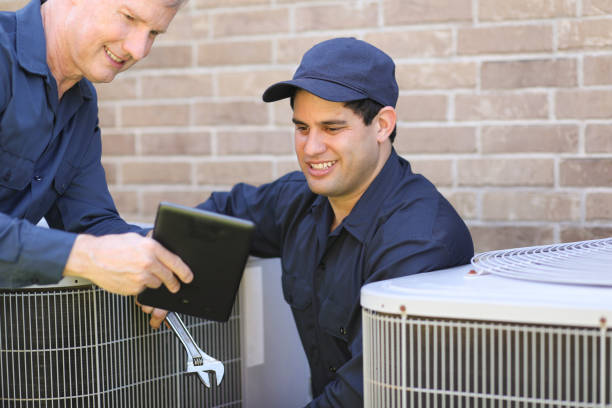 istock Multi-ethnic team of blue collar air conditioner repairmen at work. 1316667246