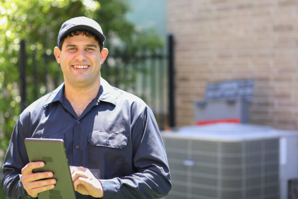 istock Latin descent, blue collar air conditioner repairman at work. 1316667296