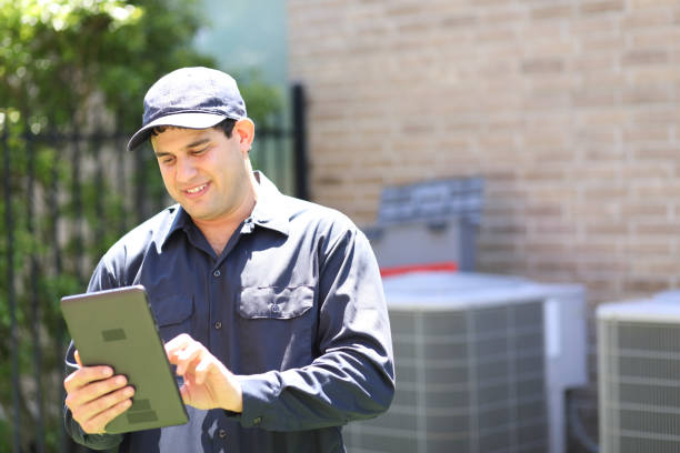 istock Latin descent, blue collar air conditioner repairman at work. 1316667317