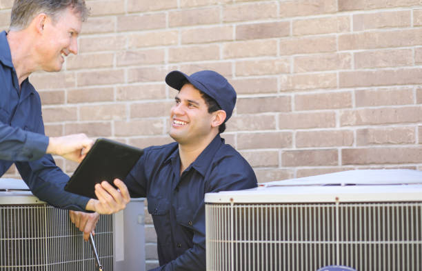 istock Multi-ethnic team of blue collar air conditioner repairmen at work. 1316667352