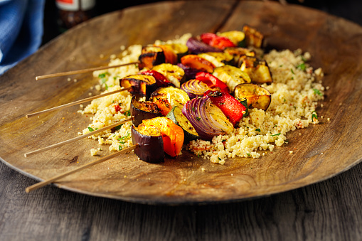 Homemade freshness roasted red onion,aubergine,courgette,pepper veggie skewers with couscous salad