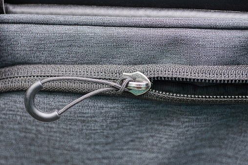 one metal zip with drawstring on the gray fabric of the garment