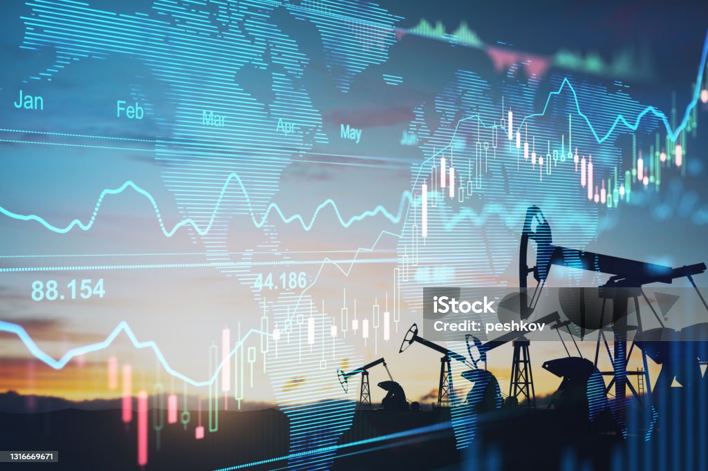 Rise in gasoline prices concept with double exposure of digital screen with financial chart graphs and oil pumps on a field. Rise in gasoline prices concept with double exposure of digital screen with financial chart graphs and oil pumps on a field Gasoline Stock Photo