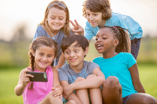 istock Happy children taking group selfies 1316669800