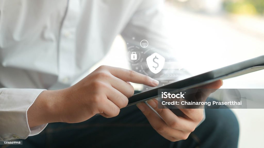 close up businessman hand use digital tablet to touchscreen by unlock password on electronic wallet with virtual interface for futuristic technology and finance concept Price Stock Photo