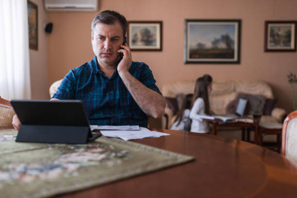 istock Man frowning when having phone conversation 1316670933