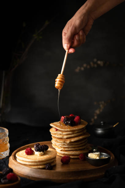istock Stack of pancakes with honey dripping on top 1316673359