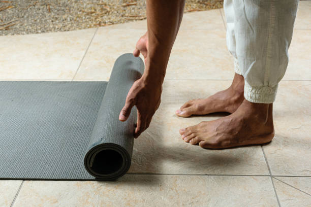 istock Closeup of yoga practitioner rolling out her mat. 1316673738