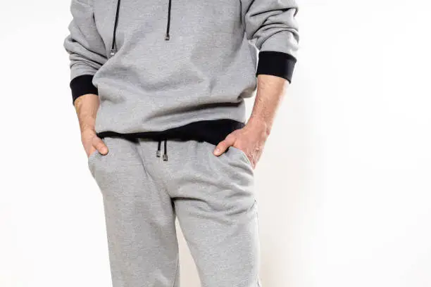 man in a gray tracksuit on a white background