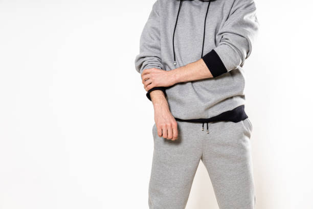 istock man in a gray tracksuit on a white background, copy space 1316675955